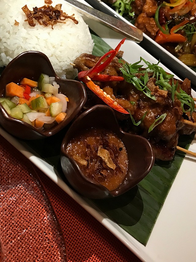 Chicken satay with peanut sauce with a side of steamed sticky rice